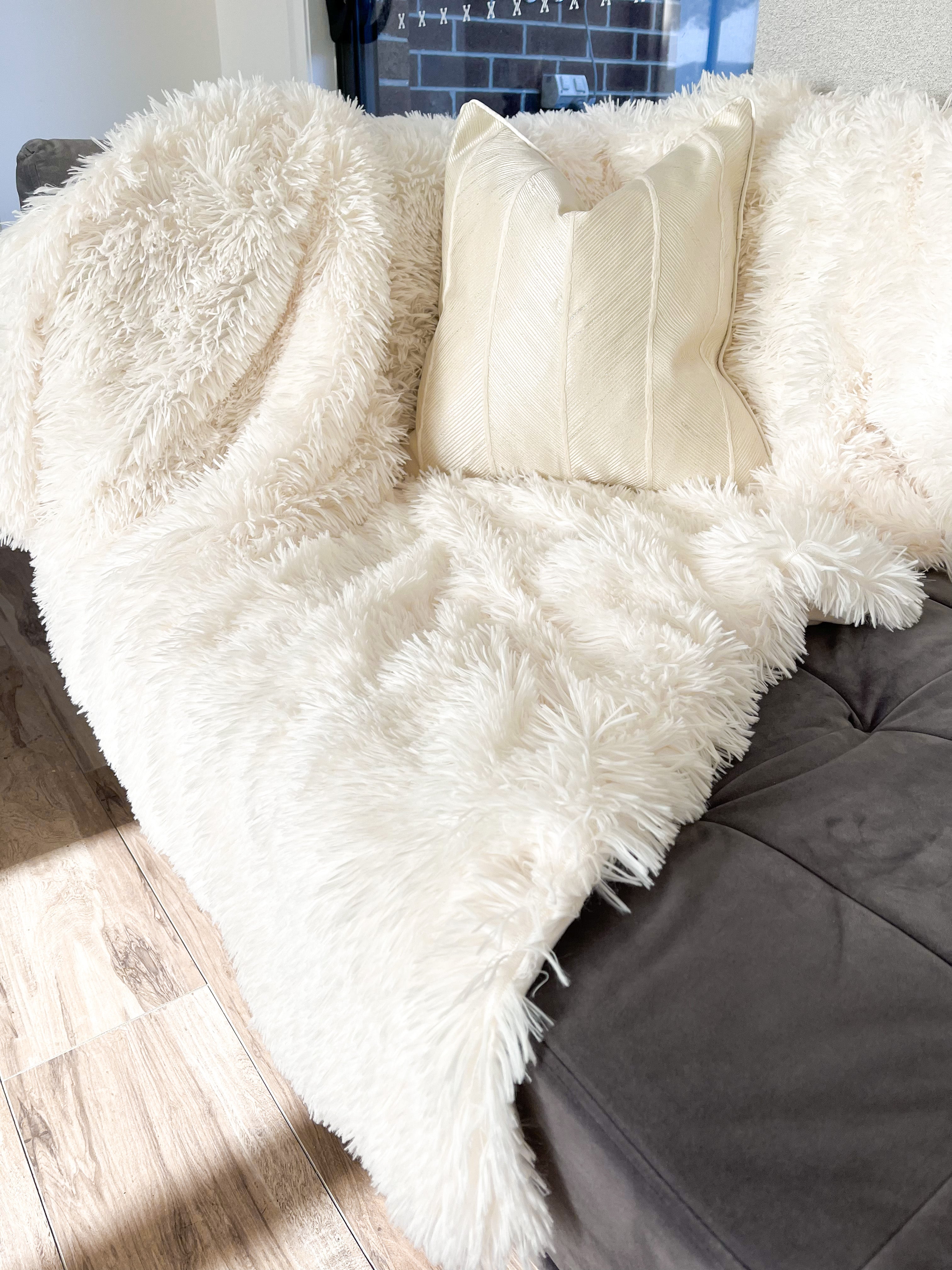 White fur throws and 2024 cushions